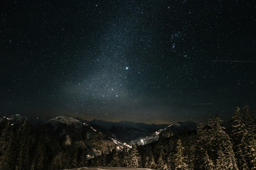alpine austrian winter landscape under starry night with the milky way