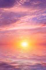 Wall Mural - Pink sunset with beautiful, colorful clouds over the sea.