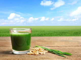 Poster - Wheat grass shot and grain on wooden table