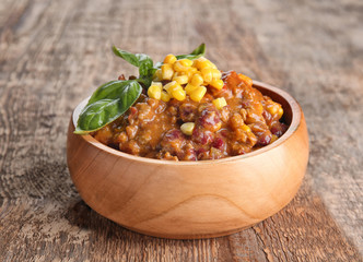 Wall Mural - Chili con carne in bowl on wooden table