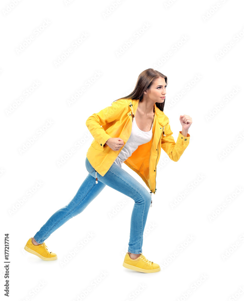 Young woman running on white background