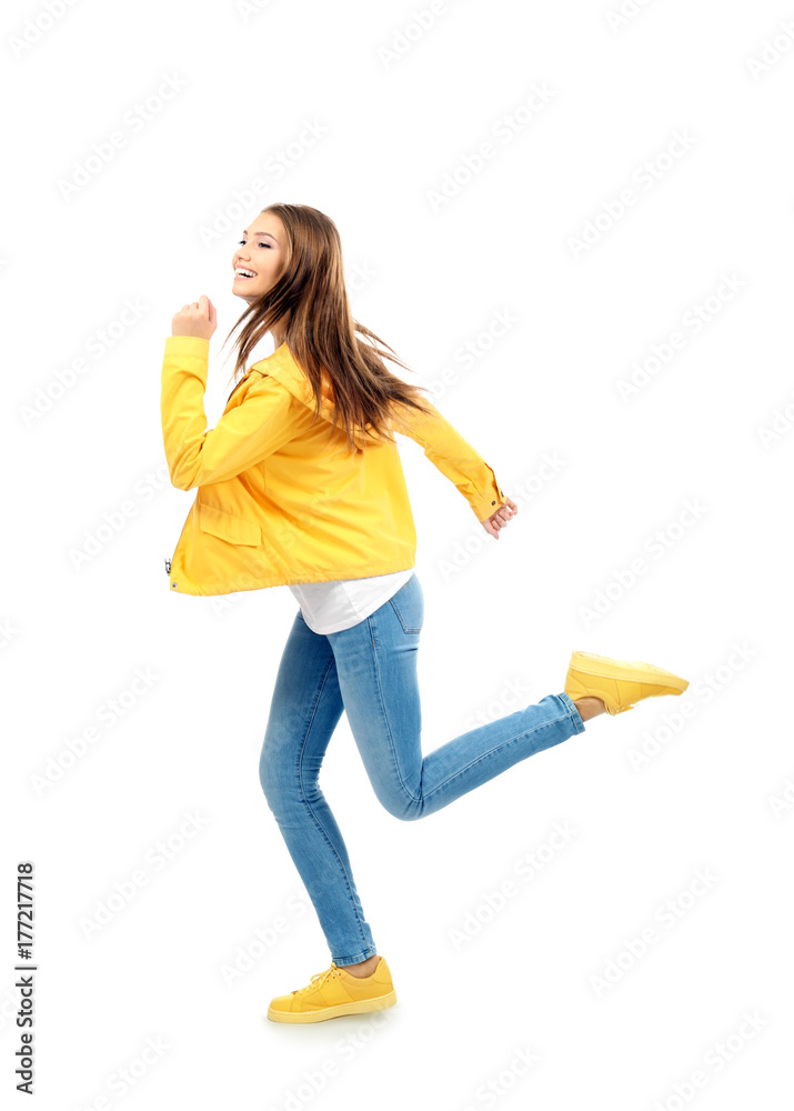 Young woman running on white background