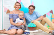 © Africa Studio - Cute baby boy with parents and birthday cake at home