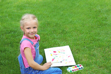 Wall Mural - Cute little girl painting picture, outdoors