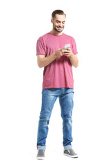 Attractive young man with smartphone on white background
