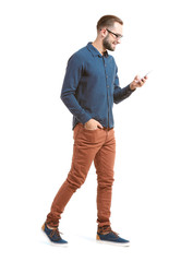 Attractive young man with smartphone on white background