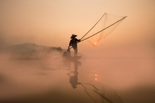 Two Fishermen Are Fishing On The Boat At Mekong River In The Morning In Nong Khai, Thailand