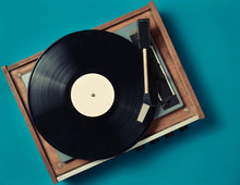 Retro Vinyl Player On A Blue Background. Entertainment 70s. Listen To Music. Top View.