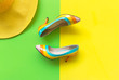 Fashion woman accessories set. Trendy fashion colorful shoes heels, stylish yellow big hat. Colorful green and yellow background.  Lifestyle Concept.