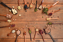 Assortment Of Beans And Lentils In Wooden Spoon On Teak Wood Background