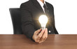 © denphumi - holding lightbulb in  hand