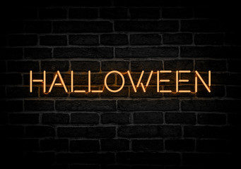 Halloween neon sign on dark wall.