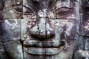 Stone murals and statue Bayon Temple Angkor Thom. Angkor Wat the largest religious monument in the world. Ancient Khmer architecture.  Location: Siem Reap, Cambodia.