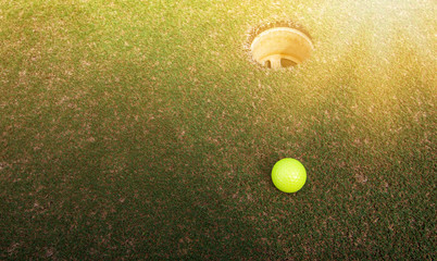 Wall Mural - Golf ball on green near golf hole Concept of success, win