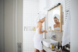 © LStockStudio - Woman Using Cosmetic in Bathroom
