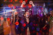 © Photodrive - Active happy male on dance floor in motion. Joyful New Year in night club, positive Christmas celebration. Disco party in blurred colors, modern youth life