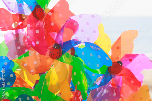 Colourful toy windmills on display at beachside in Southwold, UK Fotobehang