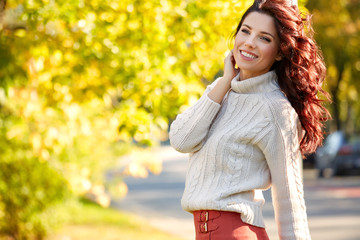 Wall Mural - Autumn woman in autumn park. Warm sunny weather. Fall concept