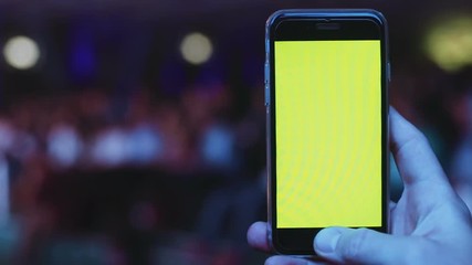 Closeup man male hand holding digital modern smart phone mobile blank mockup green screen text web content city night light bokeh beam glare blurred background chromakey display app notification gps