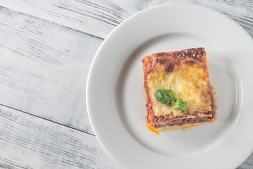 Canvas Print - Portion of lasagne on the wooden table