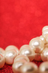 Wall Mural - Pile of pearls on red christmas background