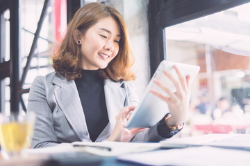 Wall Mural - businesswoman working with modern devices, student girl using digital tablet computer and mobile smart phone,business concept,selective focus,vintage color