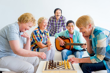 Senior people playing board games