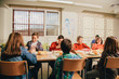 © victortorres/Stocksy - Group of Children Having Lunch in the School Canteen