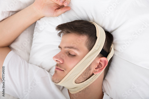 Man Sleeping With Anti Snoring Bandage Poster Mural XXL