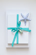 © Goodness Grace Photography/Stocksy - Christmas gift with beachy color scheme