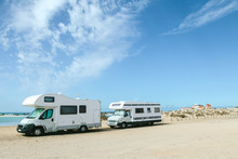 Campers Parked In A Sandy Beach