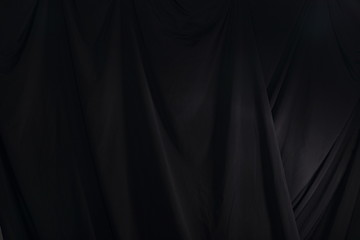 black curtain drape wave with studio lighting