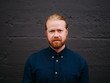 © Dylan M Howell Photography/Stocksy - Stylish man with top knot.