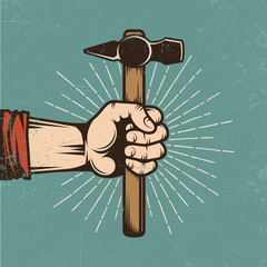 A worn out colored retro poster - the worker's hand is holding a hammer. Texture on separate layer. Vintage vector illustration.