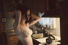 Woman Dressed In A Bra In The Kitchen