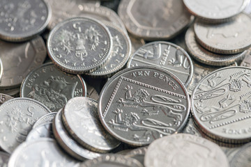 Wall Mural - Selection of low denomination British coins in a pile. Twenty pence, ten pence and five pence coins.