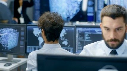 Fototapete - Neural Network and Machine Learning Engineer Working at His Workstation. Multi-Ethnic Specialists Work in the Office. Multiple Displays Show Neural Network Representation.