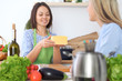 © volha_r - Two young happy woman making cooking in the kitchen. Friendship and culinary concept
