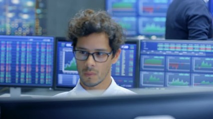 Poster - Multi-Ethnic Group of Stock Traders at the Stock Exchange Firm Office is Busy Selling and Buying Bonds and Shares, Talking to Each Other. Displays Show Relevant Graphs and Numbers.