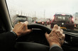 Mature mans hands clasping the Steering Wheel in his car during a rush hour Traffic jam