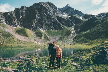 couple man and woman hiking together at mountains love and travel lifestyle concept. young family tr