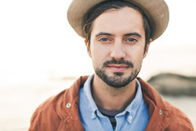 Portrait Of Stylish Man Wearing A Hat At The Beach