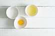 © Lawren Lu/Stocksy - Baking ingredients- sugar, egg white, egg yolk on wooden board.