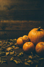 Bunch Of Pumpkins On Wooden Background With Leaves
