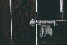 Frost On Wooden Gate And Metal Latch