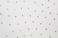Golden And Silver Shiny Little Stars On White Background