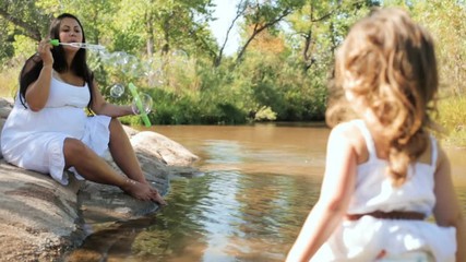 Wall Mural - Little girl playing in the creek on hot Summer day