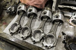 © RaymondForbes/Stocksy - Piston on Workbench in Auto Repair Shop