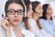 © rogerphoto - Call center operator.Young beautiful business woman in headset