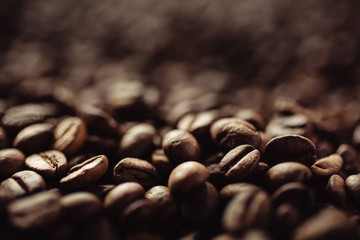 Wall Mural - Closeup shot of coffee beans with select focus and blur background